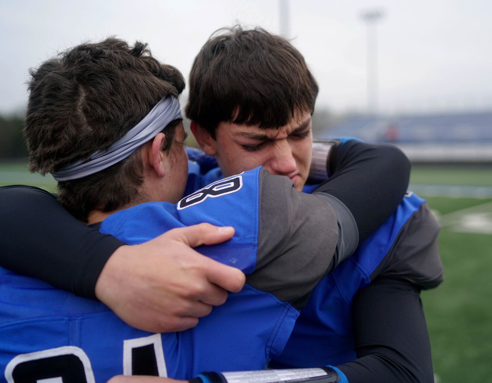 Caleb Pezold hugs Hunter Kistner